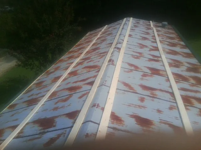 Rusted metal roof panels with new wood purlins before replacement — Storm Damage Roof Repair in Harleysville by Roofing Brothers