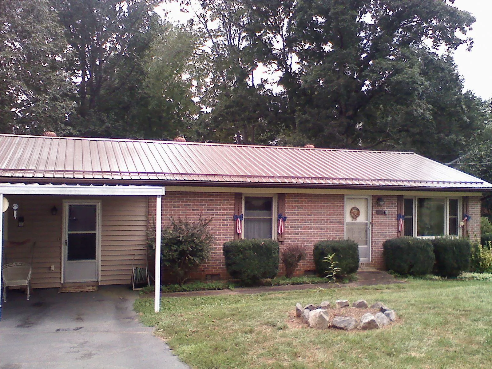 Bronze metal roof and carport on a brick ranch home — Roof Repair work by our crew in Harleysville